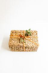 Water hyacinth basket with ribbon & eucalyptus leaves